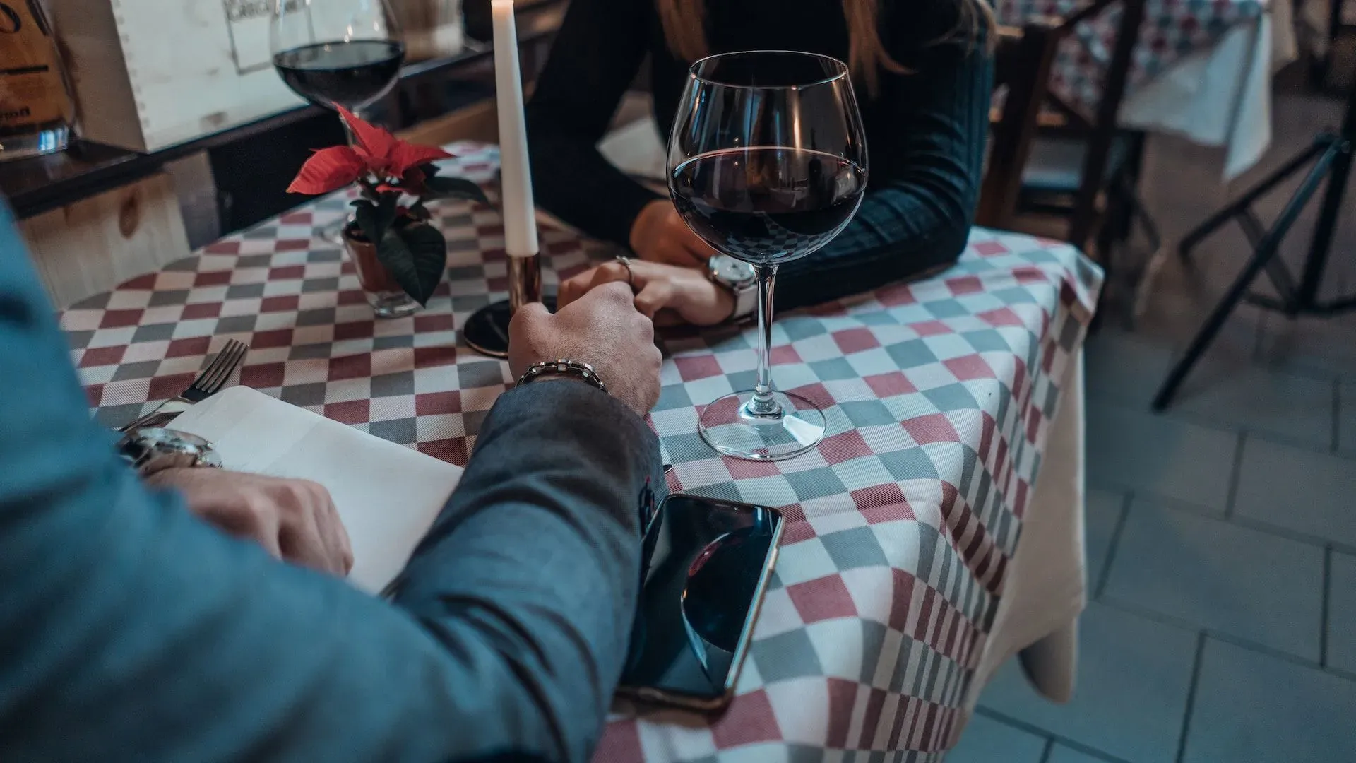 Woman wearing black sweater holding hand with man wearing gray suit jacket photo